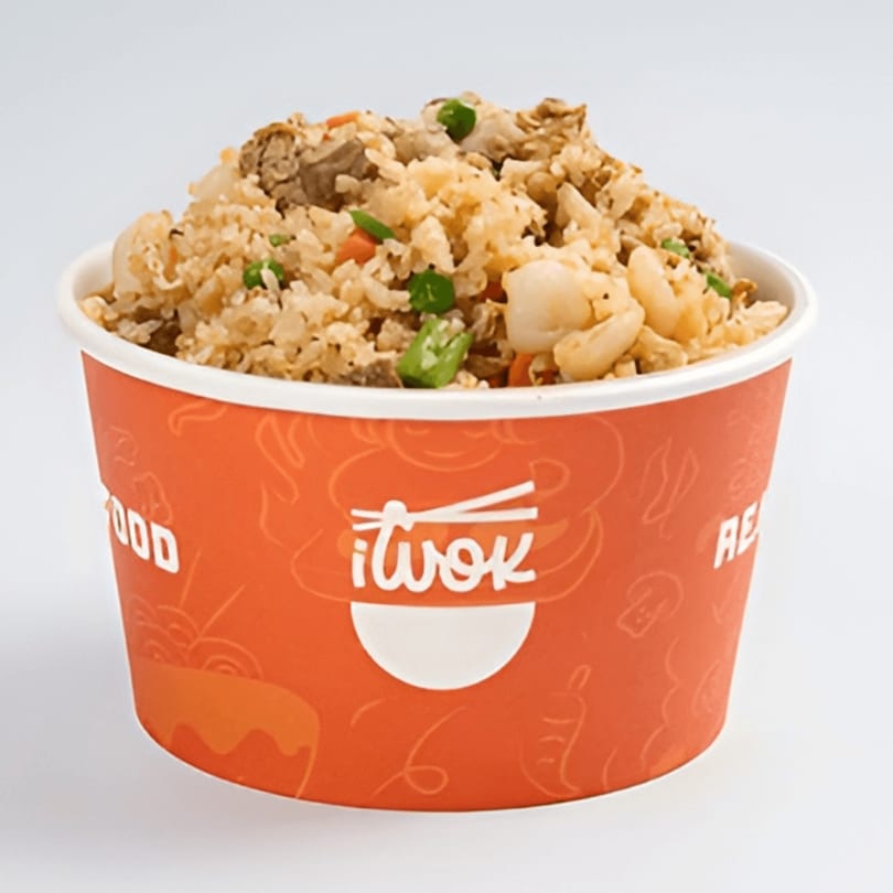 Fried rice with meat, peas, and carrots in an orange iWok branded container.